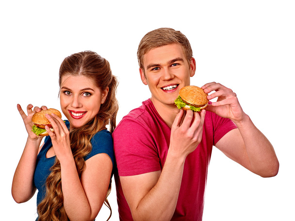 Mann und Frau essen ein großes Sandwich mit Cola. isoliert. - Foto, Bild