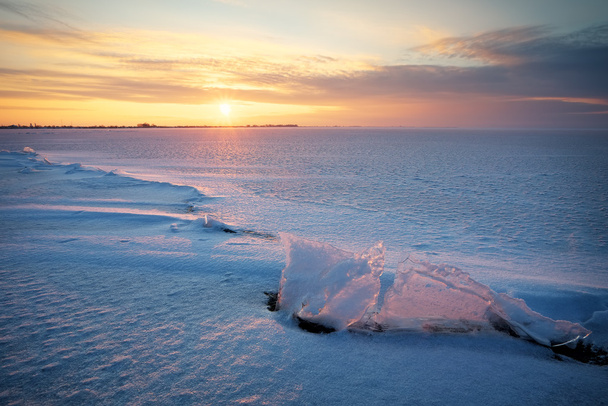 Beautiful winter landscape with sunset sky frozen reservoir - Фото, зображення