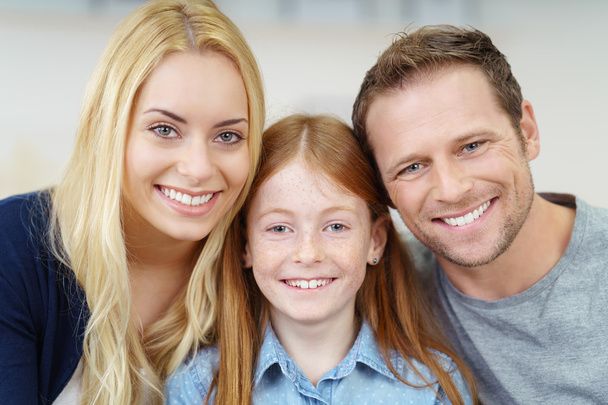 Smiling portrait of a happy young family - Foto, Imagen
