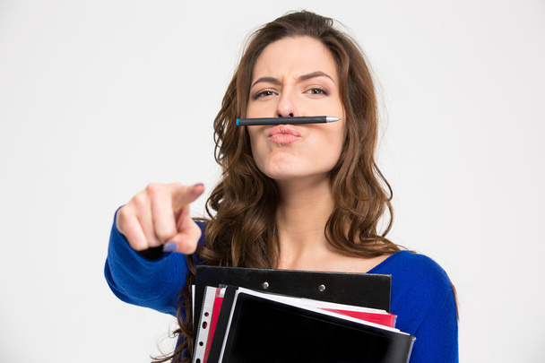 Funny woman simitating moustache with pen and pointing on camera  - Fotoğraf, Görsel