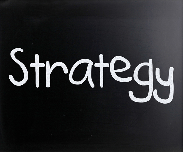 "Strategy" handwritten with white chalk on a blackboard - 写真・画像