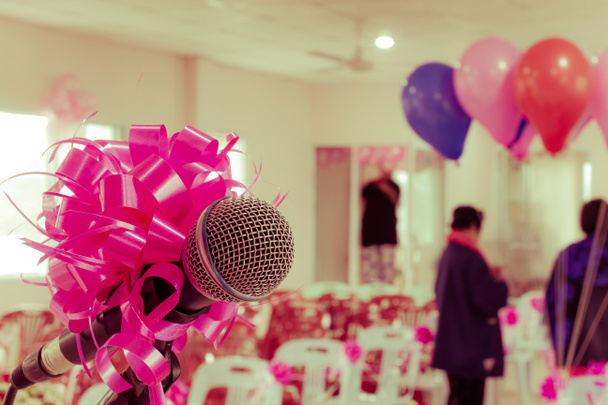 microphone with pink bow and ribbon in wedding ceremony hall - Photo, Image