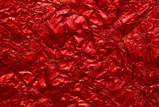 Red shiny wrinkle foil paper as background - Photo, image