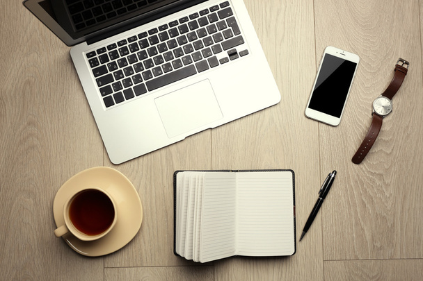 Laptop, mobile phone, notebook, coffee cup, watch and pen - Photo, Image