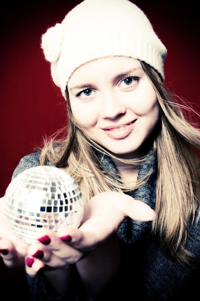 Portrait of beautiful blond young woman and christmas ball on - Foto, afbeelding