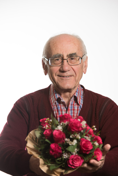 old man with flowers - Фото, изображение