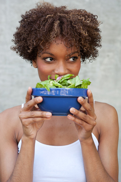 Pretty African American woman with salad - Фото, зображення
