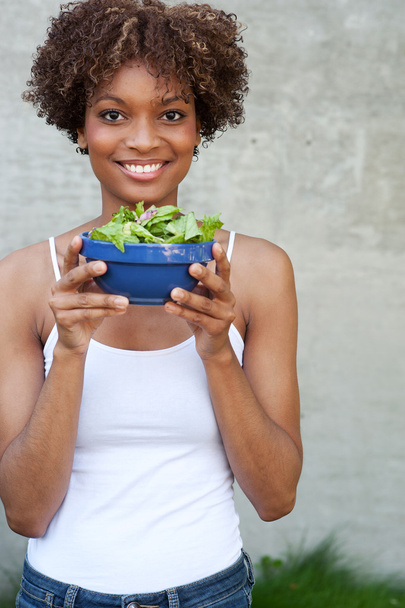 Pretty African American woman with salad - Фото, изображение
