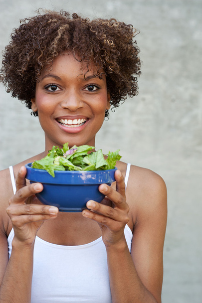Pretty African American woman with salad - Фото, зображення