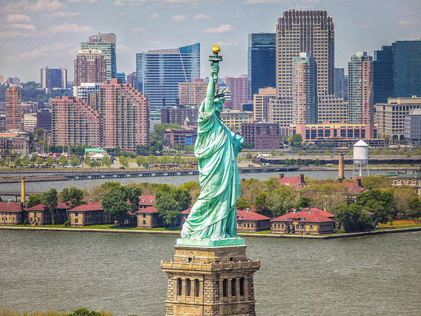 The Statue of Liberty and skyscrapers on background, New York City, USA - Photo, Image