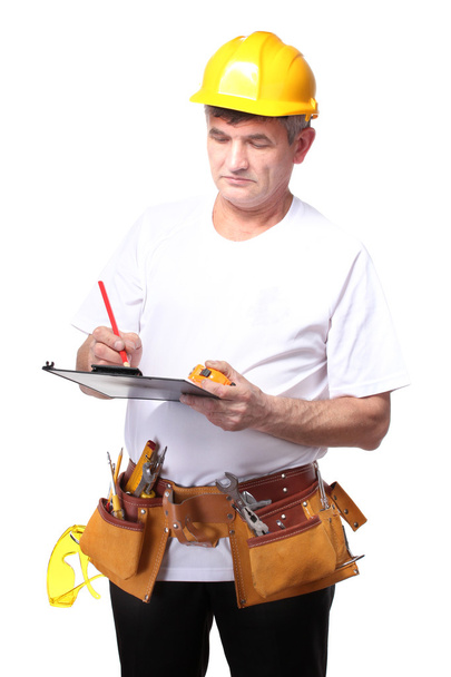 Builder with belt construction writing on document isolated on white - Fotografie, Obrázek