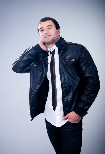 Fashionable man in jacket on gray background - Foto, immagini