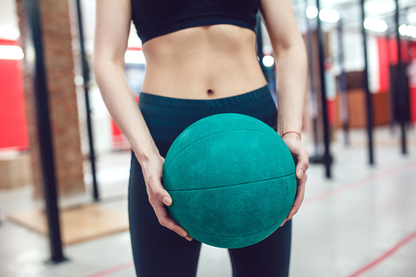 Sport girl is preparing for exercise with ball - Φωτογραφία, εικόνα