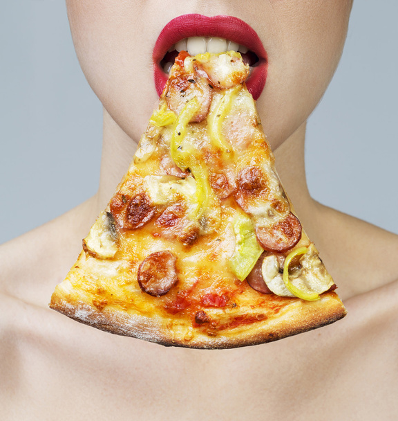 Young hungry woman eating a piece of pizza, isolated on white. Perfect skin and nature make up. - Photo, Image