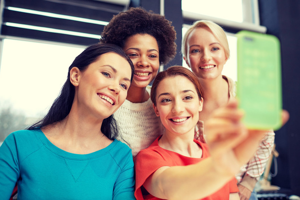 happy young women taking selfie with smartphone - Фото, изображение