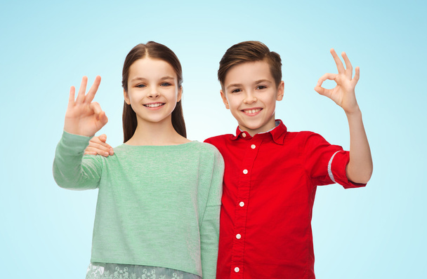 happy boy and girl showing ok hand sign - Foto, imagen