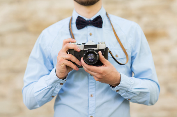 close up of hipster man with film camera in city - Valokuva, kuva