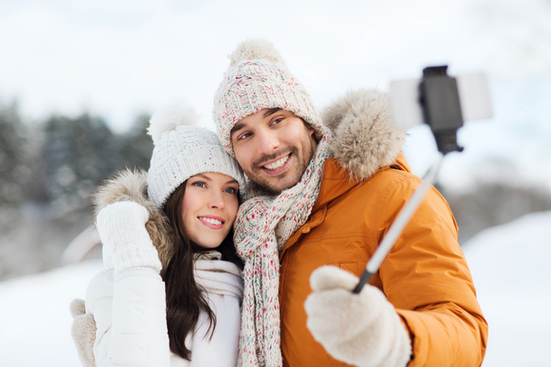 happy couple taking selfie by smartphone in winter - Фото, изображение