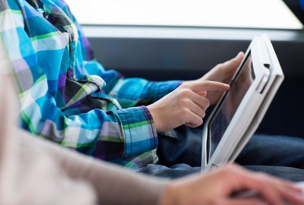 close up of boy with tablet pc in travel bus - Valokuva, kuva
