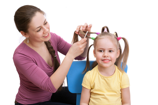 mother making her daughter hairstyle - Photo, Image