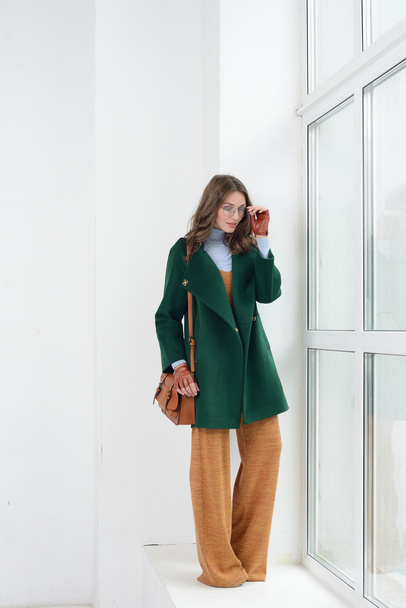 Girl in studio posing at coat - Φωτογραφία, εικόνα