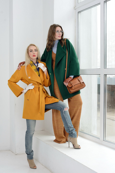Girls in studio posing at coats - Foto, Imagem