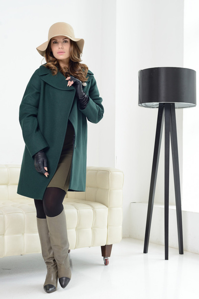 Girl in studio posing at coat - Foto, Imagen