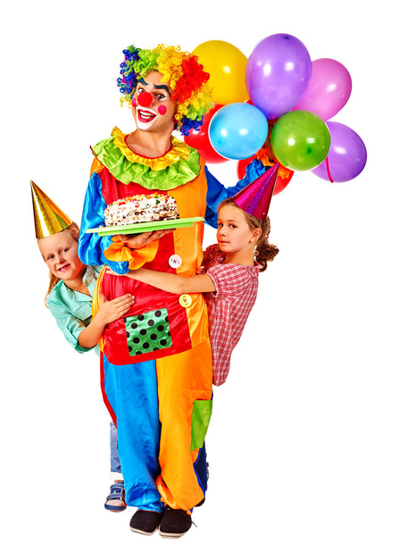 Clown holding cake on birthday with group children. - Photo, Image