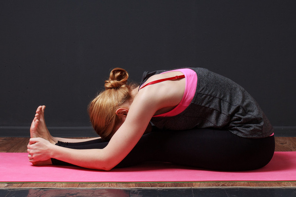 Young blonde woman doing yoga exercise - Photo, Image
