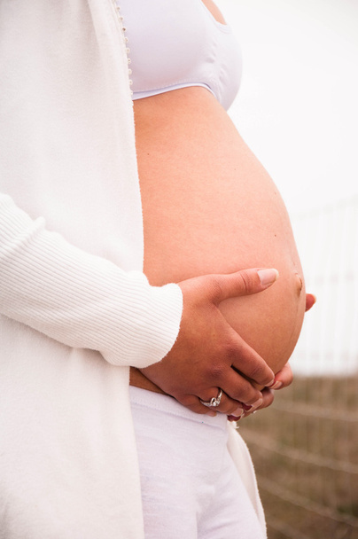 Pregnant woman's belly - Фото, изображение