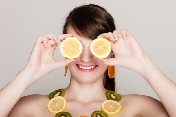 Diet. Girl with necklace of fresh citrus fruits - Фото, зображення