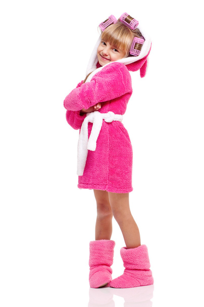 Pretty little girl in pink bathrobe with curlers - Фото, изображение