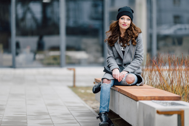 Young woman sitting on the street - Zdjęcie, obraz