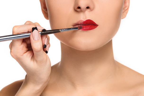 Beautiful female lips with make-up and brush - 写真・画像