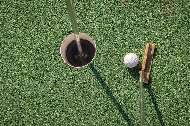 Putter with golf ball and hole - Фото, зображення
