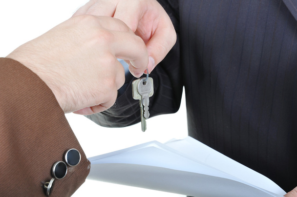 Two businessmen hands and the key, paper agreement - Foto, imagen