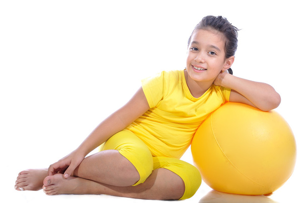 Little beautiful girl in yellow with yellow ball - 写真・画像