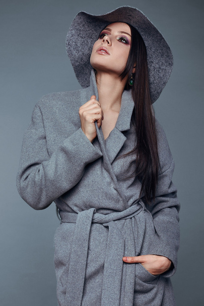 young fashion brunette woman beauty in gray coat and hat - Photo, Image