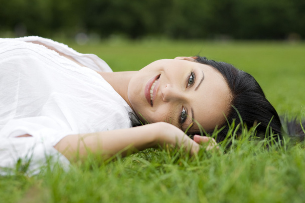Woman laying on grass - Φωτογραφία, εικόνα