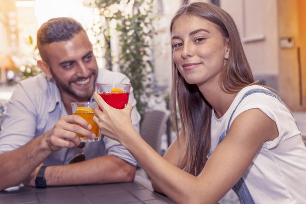 young couple takes a drink in a downtown bar - Foto, Imagen