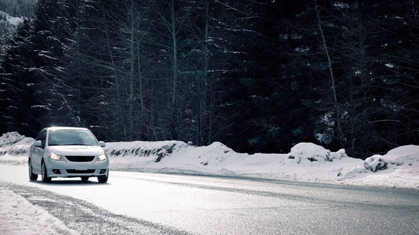 Auto passiert winterliche Autobahn in der Sonne - Filmmaterial, Video