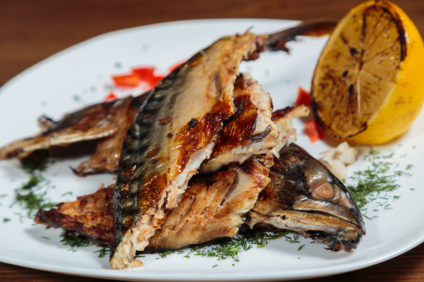 Smoked mackerel with vegetables grilled on a white plate. - Fotografie, Obrázek