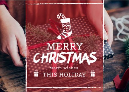 Platilla de diseño Merry Christmas Greeting Woman Wrapping Gift Card
