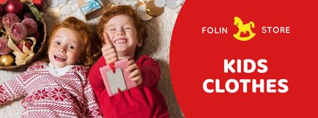 Platilla de diseño Christmas Offer Kids in Red Sweaters Facebook cover