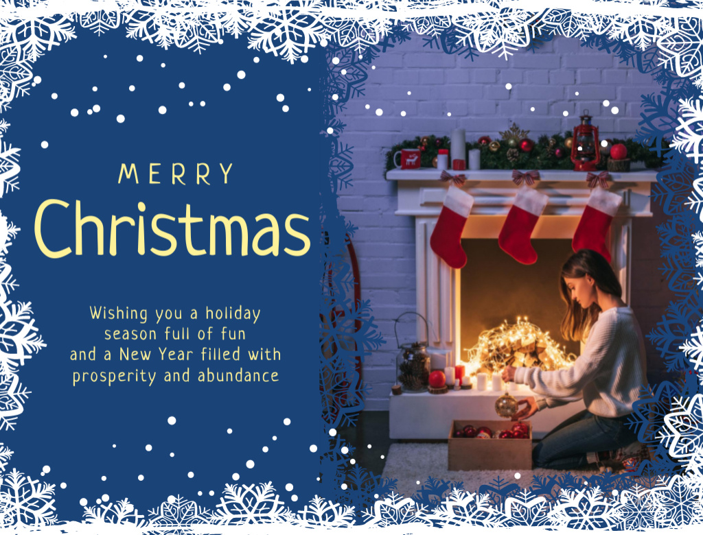 Platilla de diseño Snowy Christmas Greeting Near Fireplace With Stockings Postcard 4.2x5.5in